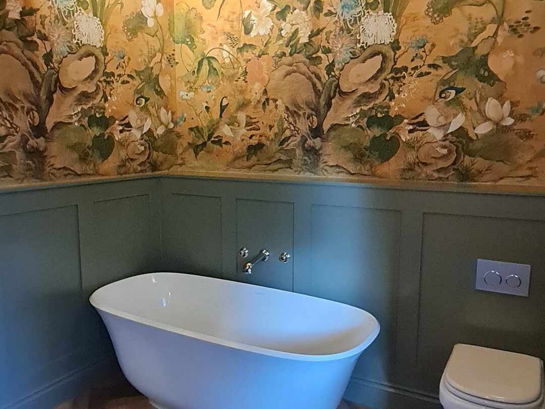 The bath and wall-hung toilet beneath an old beam