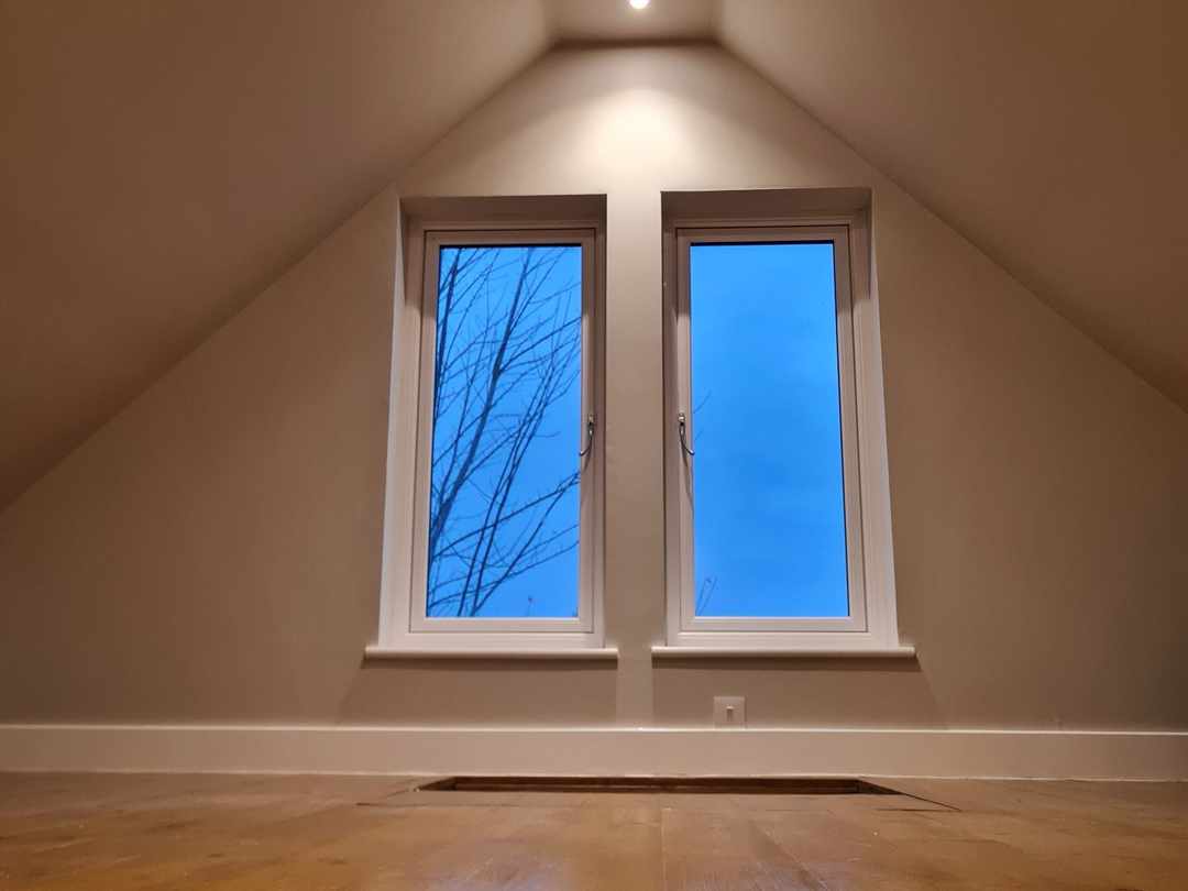 Two windows in the gable end of the room