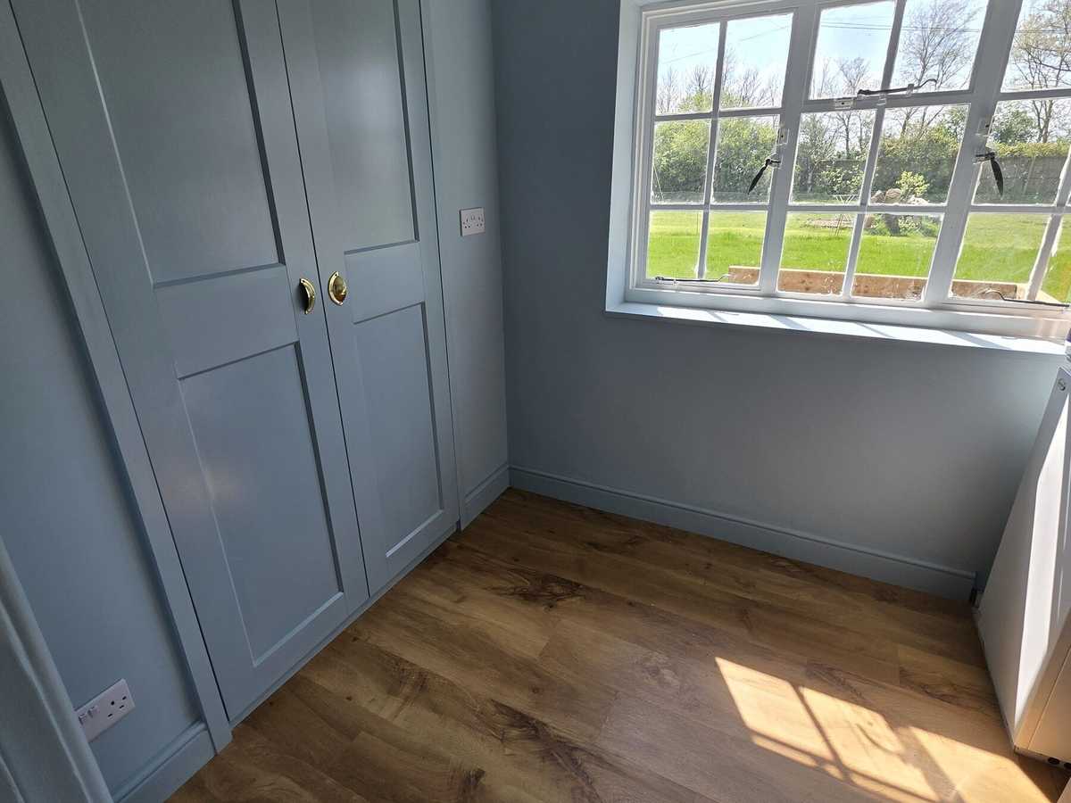 A freshly painted bedroom with fitted wardrobe doors